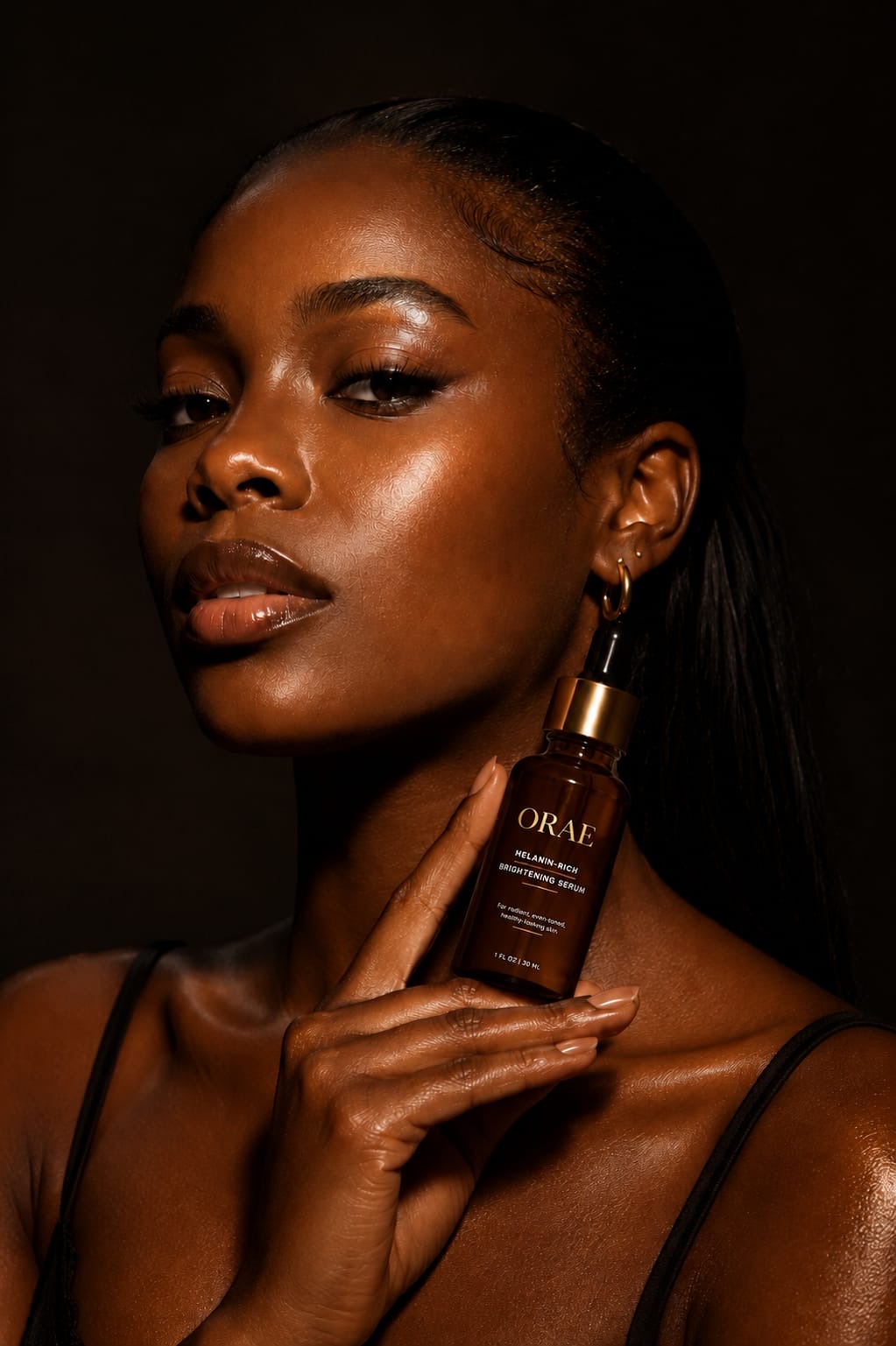 ORAE campaign portrait of a woman with luminous melanin-rich skin and the gold ORAE melanin-rich skincare wordmark